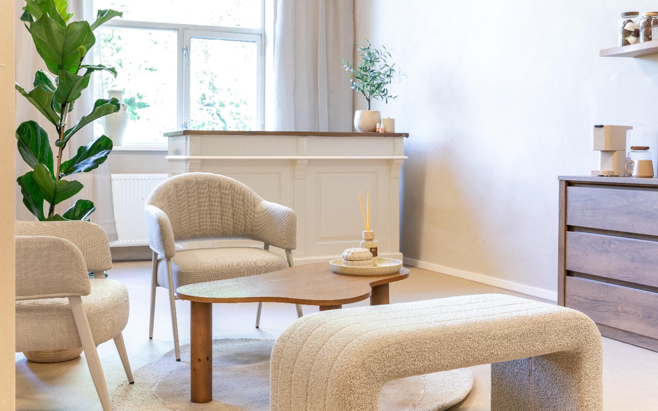 Balie, fauteuils en een bouclé bank bij het raam